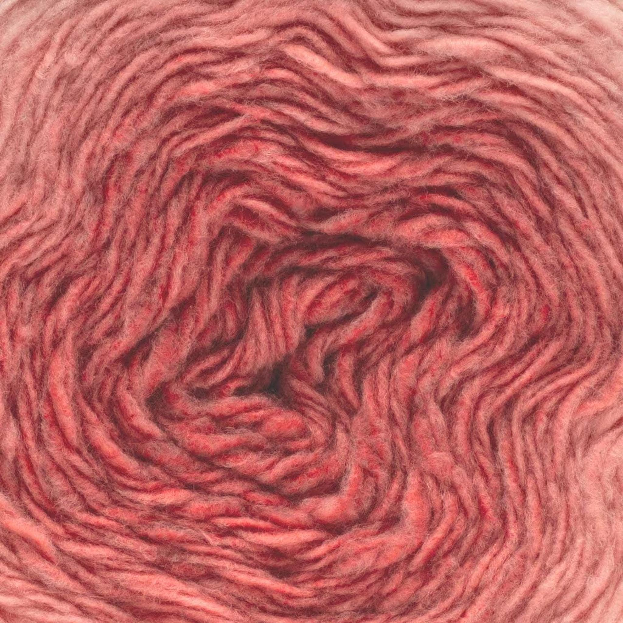 A close-up of a ball of yarn, showing a gradient from light pink to dark reddish-pink.