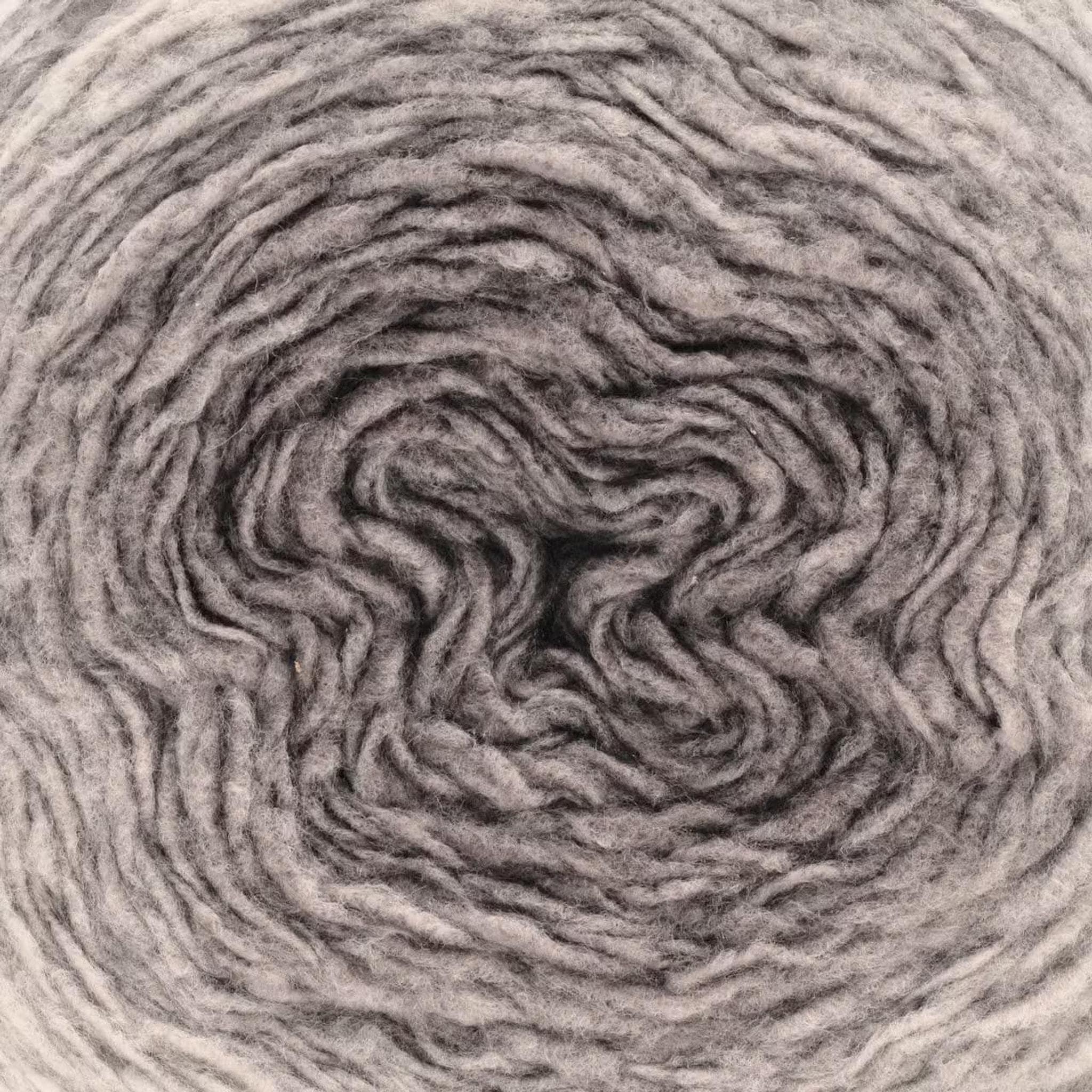 A close-up of a ball of yarn showing a gradient from light gray to dark gray, with visible texture.