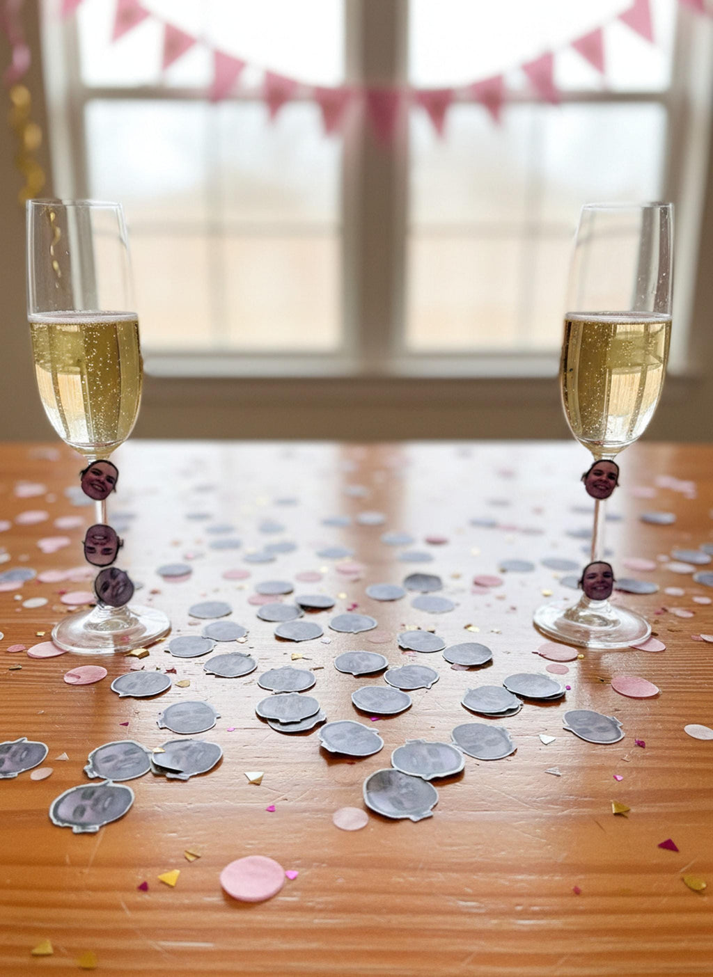 Table decorated with custom face confetti stickers and party glassware.