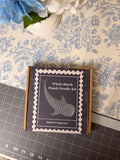 A cardboard box labeled Whale Shark Punch Needle Kit sits on a floral surface.